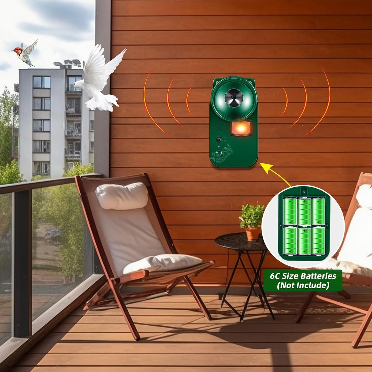 Motion activated bird deterrent: device on patio and battery compartment.