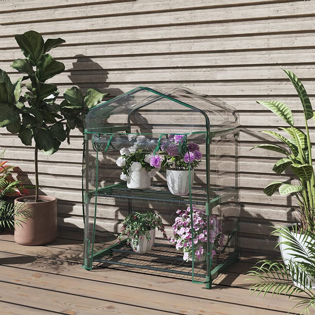 2 tier mini greenhouse: greenhouse beside outdoor wall.