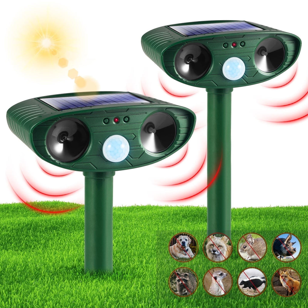 Solar motion activated animal repeller: two green solar repellers on stakes.