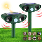Solar motion activated animal repeller: two green solar repellers on stakes.
