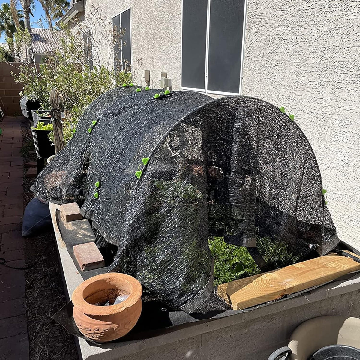Fiberglass garden hoops: shade cloth over garden hoops.